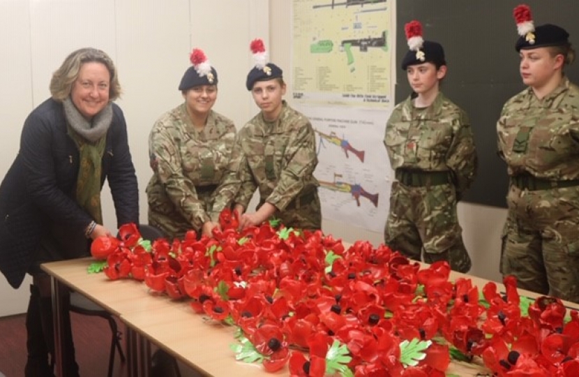 Anne-Marie with cadets attaching poppies to their Weeping Window display.